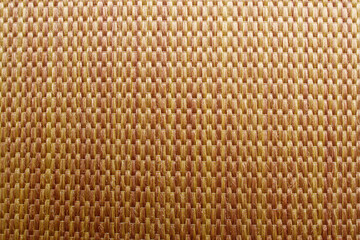 Wicker background made of natural straw. Full frame of densely woven straw pattern. Natural, natural background