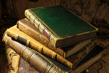 Ancient books on old map background. The covers of a very old books