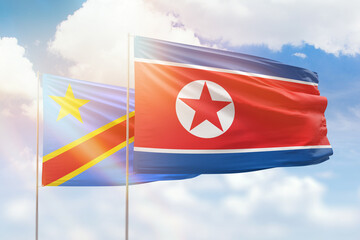 Sunny blue sky and flags of north korea and dr congo