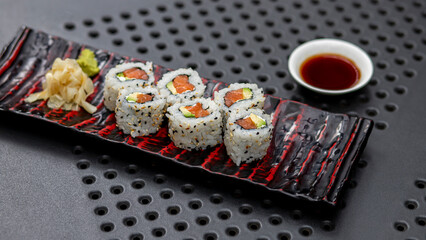 sushi with chopsticks with red salmon