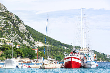 Fototapeta na wymiar Ships in port to the Mediterranean Sea, Omis, Croatia 