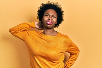 Young african american woman wearing casual clothes suffering of neck ache injury, touching neck with hand, muscular pain