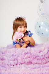 Fototapeta na wymiar Little girl with peony flower