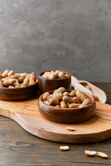 Image of wooden spoons with peanuts on a wooden table