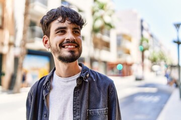 Fototapeta premium Young hispanic man smiling happy standing at the city.