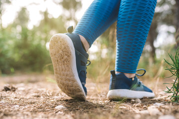 close-up of a young woman's blue sports shoes. woman athlete playing sport outdoors. concept of wellbeing and healthy living.