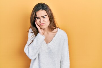 Young caucasian girl wearing casual clothes touching mouth with hand with painful expression because of toothache or dental illness on teeth. dentist
