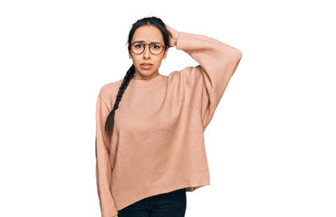 Young hispanic girl wearing casual clothes and glasses confuse and wonder about question. uncertain...