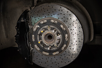 Massive brake caliper on carbon brake disk on a performance car