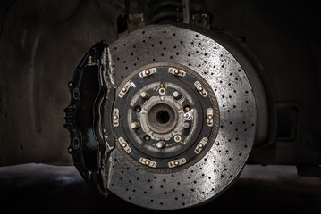 Massive brake caliper on carbon brake disk on a performance car - obrazy, fototapety, plakaty