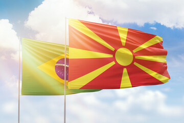 Sunny blue sky and flags of north macedonia and brazil