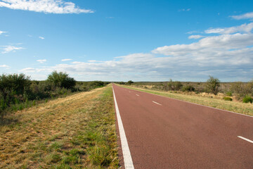 A long straight road leading to nowhere in a rural landscape