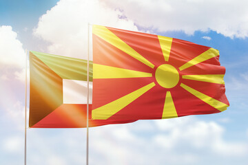 Sunny blue sky and flags of north macedonia and kuwait