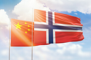 Sunny blue sky and flags of norway and china