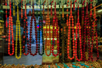 Rosary showcase and rosaries in various sizes and colours.