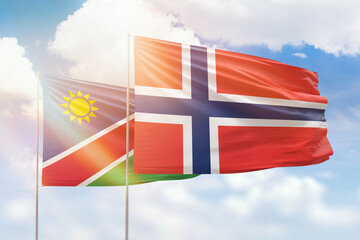 Sunny blue sky and flags of norway and namibia