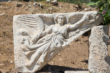Stone carving of goddess Nike, Ephesus or Efes, Kusadasi, Turkey. Marble relief of winged Nike Goddess of Victory Ephesus Turkey. Carved marble statue. Sculpture of goddess Nike in archaeological site