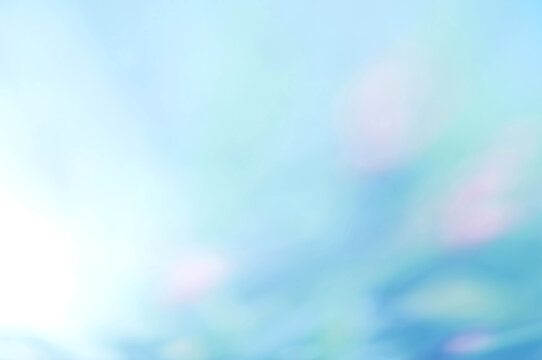 Light blue Leaf background. Blurred leaves and circular bokeh. Abstract wallpaper for backdrop and design