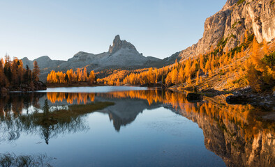 Amazing autumn scenery in the Dolomites mountains by the Lake Federa in the fall. National Unesco park in Italy.
