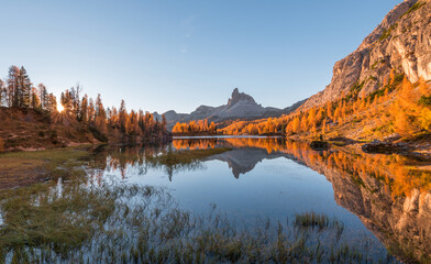 Amazing autumn scenery in the Dolomites mountains by the Lake Federa in the fall. National Unesco park in Italy.
