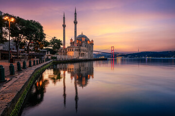 Fototapeta na wymiar Istanbul. Image of Ortakoy Mosque with Bosphorus Bridge with mirror effect in the water in Istanbul during beautiful sunrise.