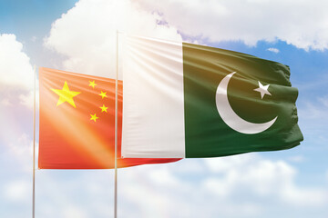 Sunny blue sky and flags of pakistan and china