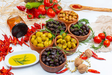 olives, green and black olives, olive oil, honey, tomato, walnut, red chili pepper concept