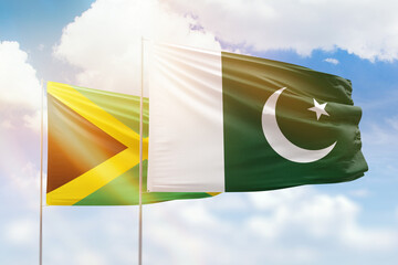 Sunny blue sky and flags of pakistan and jamaica
