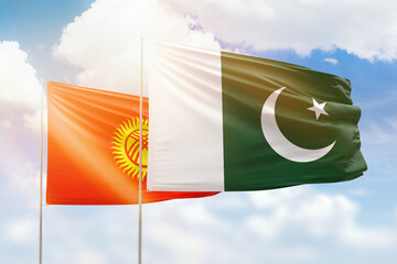Sunny blue sky and flags of pakistan and kyrgyzstan