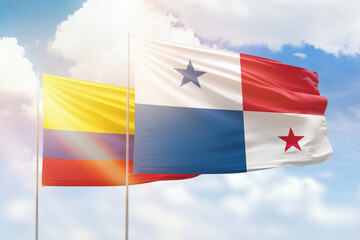 Sunny blue sky and flags of panama and colombia