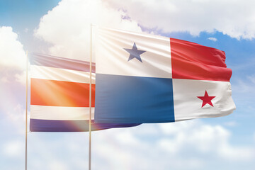 Sunny blue sky and flags of panama and costa rica