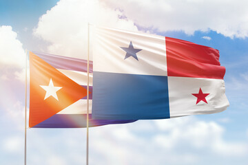 Sunny blue sky and flags of panama and cuba