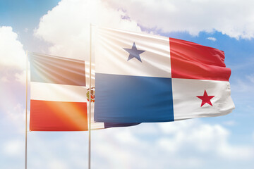 Sunny blue sky and flags of panama and dominican republic
