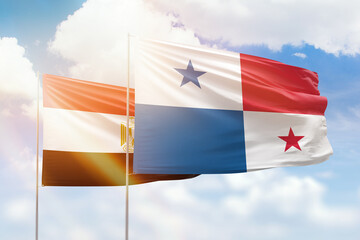 Sunny blue sky and flags of panama and egypt