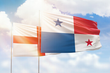 Sunny blue sky and flags of panama and england