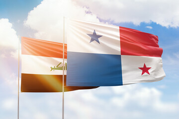 Sunny blue sky and flags of panama and iraq