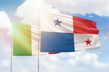 Sunny blue sky and flags of panama and italy