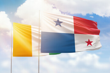 Sunny blue sky and flags of panama and ivory coast
