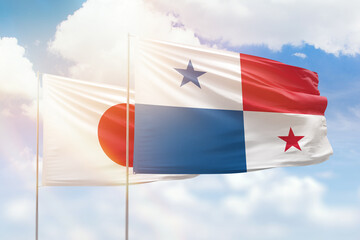 Sunny blue sky and flags of panama and japan