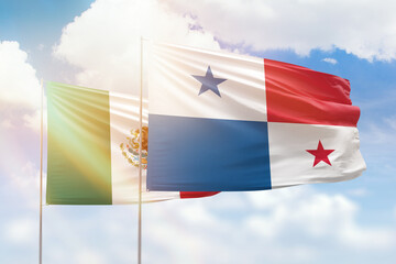 Sunny blue sky and flags of panama and mexico
