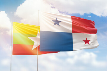 Sunny blue sky and flags of panama and myanmar