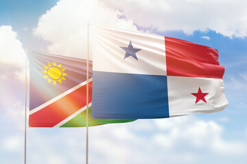 Sunny blue sky and flags of panama and namibia