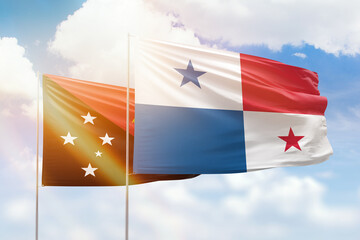 Sunny blue sky and flags of panama and papua new guinea