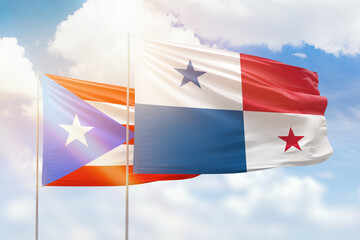 Sunny blue sky and flags of panama and puerto rico