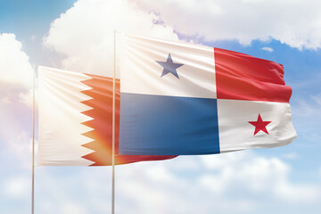 Sunny blue sky and flags of panama and qatar