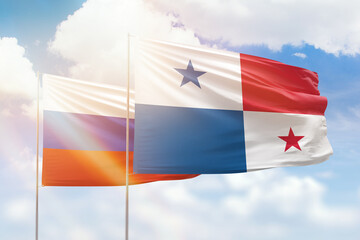 Sunny blue sky and flags of panama and russia