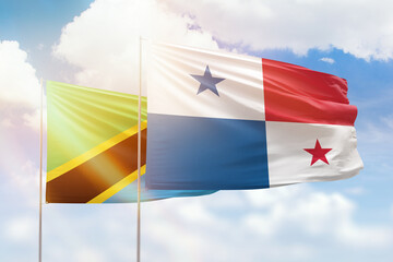 Sunny blue sky and flags of panama and tanzania