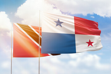 Sunny blue sky and flags of panama and trinidad and tobago