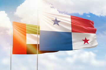 Sunny blue sky and flags of panama and uae
