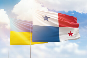 Sunny blue sky and flags of panama and ukraine